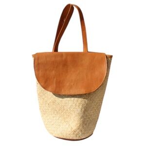 Street Level Stella Wicker Basquet Backpack with a leather flap.